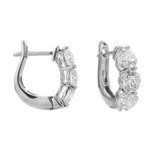 18KT white gold three stone hoop earrings with 1.50ctw round...
